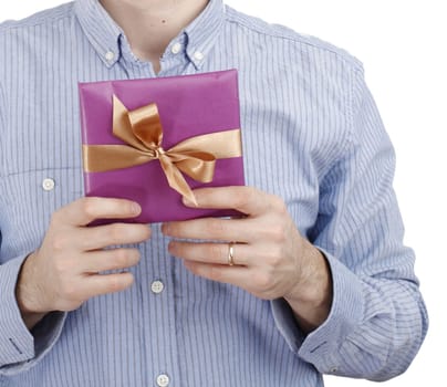Young man holding a present in hands.