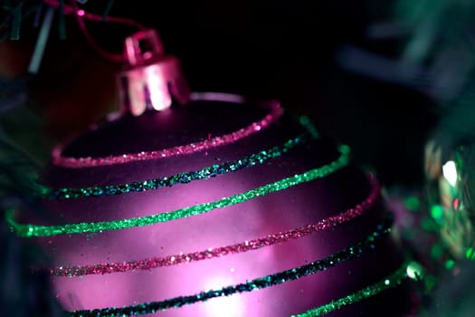 Close up of Christmas ornaments on tree.