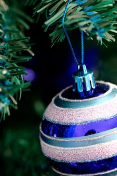 Close up of Christmas ornaments on tree.