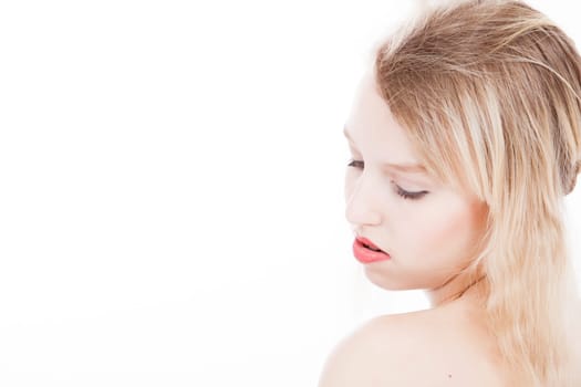 Portrait from young blond woman on a white background with much skin visible