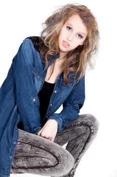Young tough blond teenage girl with jeans blouse on a white background