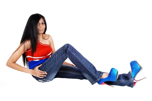 A young Hispanic woman with long black hair lying on the floor isolated for.white background..