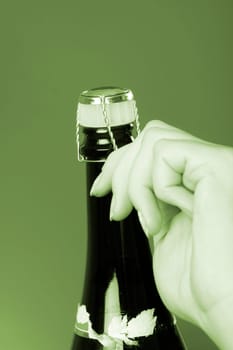 Woman hands opening champagne bottle