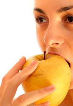 Beautiful young woman eating yellow apple. Isolated over white