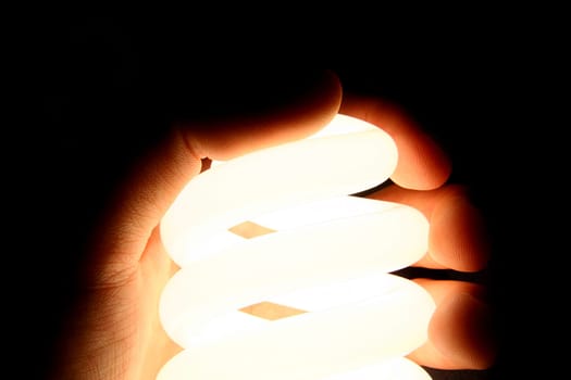Alight Spiral Bulb in Hand - macro & isolated on black