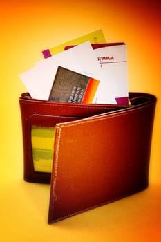 Brown leather wallet isolated on yellow
