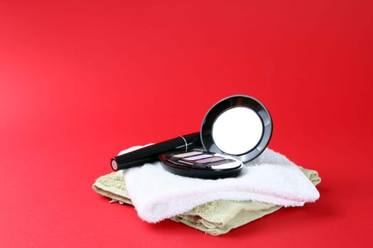 Cosmetics isolated on red background