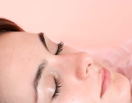 Beautiful young woman sleeping on bed in her bedroom at home in the morning.