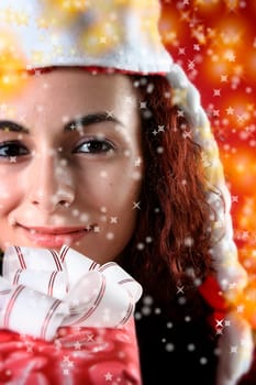 woman with a gift in her hands and snowflakes
