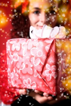 woman with a gift in her hands and snowflakes