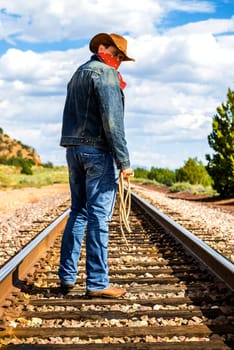 famous cow-boy boots and feets across train tracks