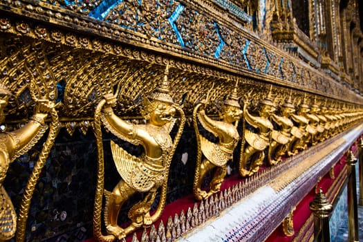 Temple of the Emerald Buddha. Gold ornamental patter statuettes.Wat Pra-keaw Bangkok,Thailand.