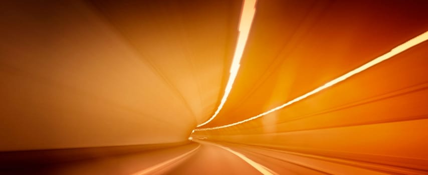 Car lights trails in a tunnel