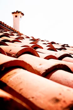 Red tile roof with chimney.