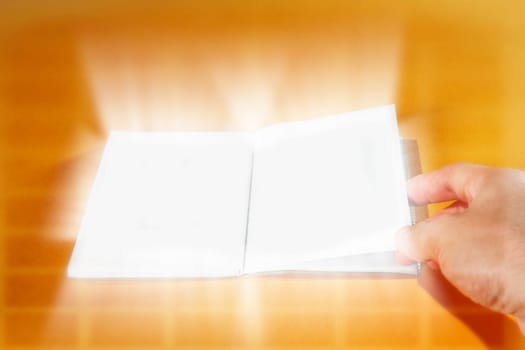 Opened empty photo album isolated on orange.