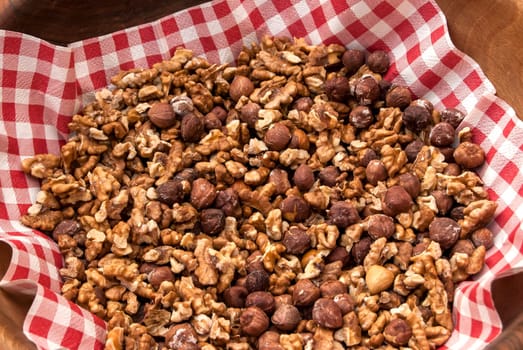 Salted roasted hazelnuts and walnuts in bowl