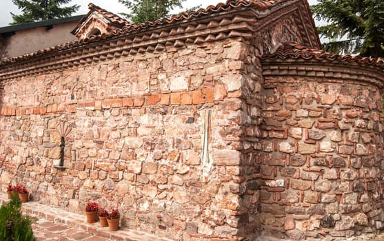 View to stonewall facade of ancient  basilica style orthodox church