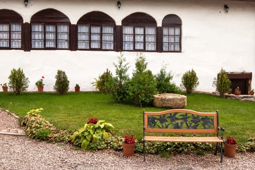 Part of orthodox monastery courtyard with bench