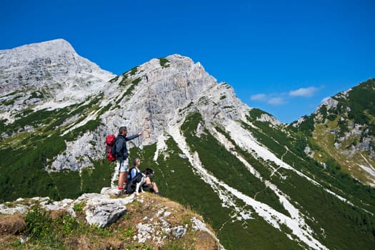 Hikers with backpacks enjoying view from top of a mountain