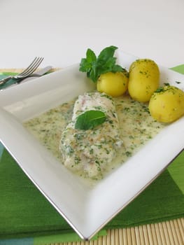 Fish on herb sauce with potatoes