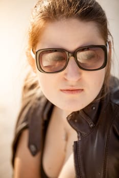 Closeup portrait of beautiful woman in sunglasses at desert