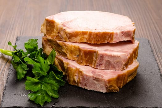 Three smoked slices of Kassel pork with parsley