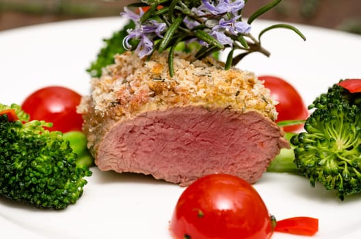 Roasted lamb back fillet with thyme and tomatoes