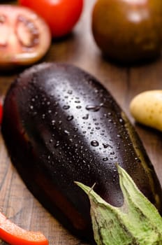 Aubergine with water drops in portrait format