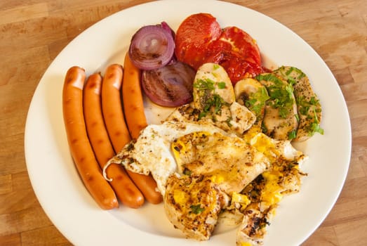 Plate with homemade English breakfast on wooden background
