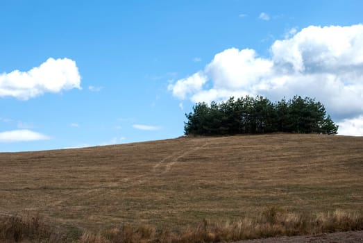 Mountain hill landscape on clear autumn day with clouds