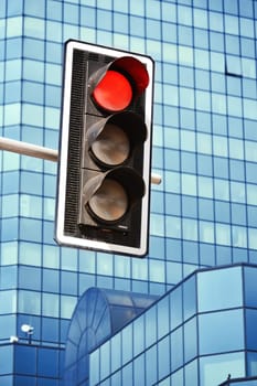 Traffic lights over modern business architecture