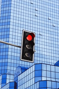 Traffic lights over modern business architecture