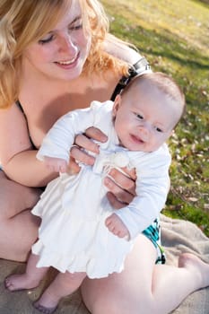 Young mother is having some nice time with her baby on a sunny day