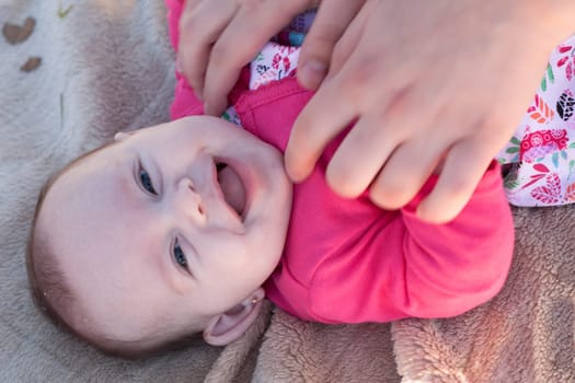 Young mother is having some nice time with her baby on a sunny day