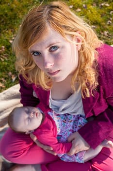 Young mother is having some nice time with her baby on a sunny day