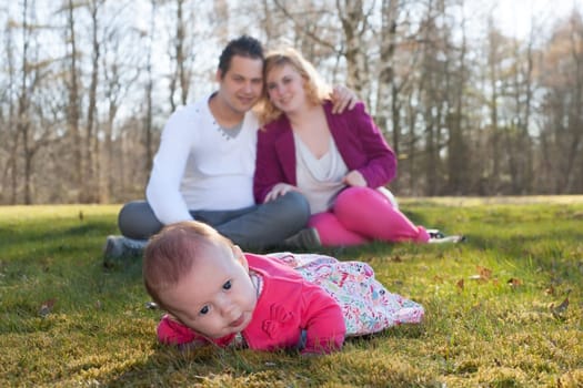 Young family is having  nice time with their baby on a sunny day