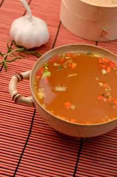 Asian soup an a bamboo mat