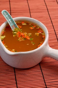 Asian soup an a bamboo mat