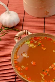 Asian soup an a bamboo mat