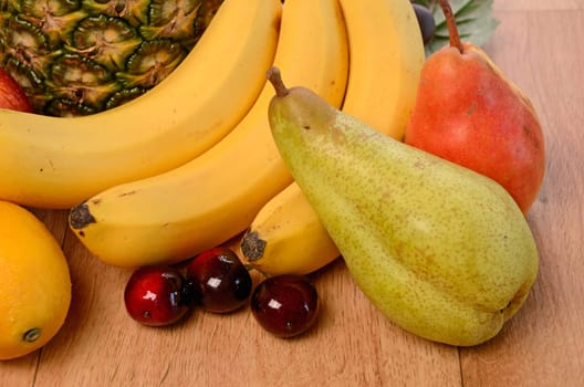 Fresh fruits on a wooden background