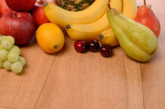 Fresh fruits on a wooden background