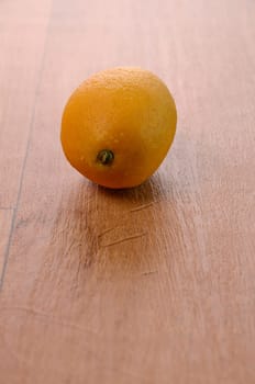 Fresh lemon fruit on a wooden background