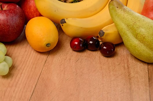 Fresh fruits on a wooden background
