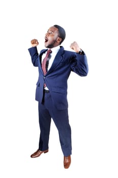 A young black business man standing in a suit and tie, holding up his.hands and screaming for happiness, isolated for white background..