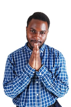 A young black man standing isolated for white background, folding his hands .and praying..