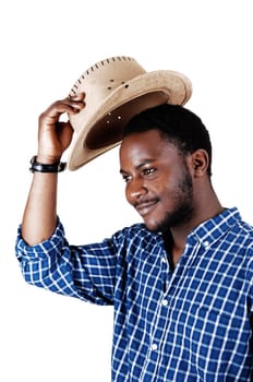 A handsome black man in a blue shirt lifting his cowboy hat and smiling.isolated for white background..