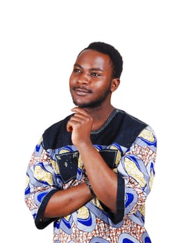 A handsome young black man in a colorful shirt and his hands in his.shin, looking up isolated for white background..