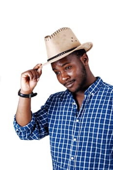 A smiling young black man in a blue shirt and an cowboy hat on his head.standing isolated for white background..