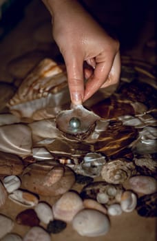 Closeup photo of woman searching for pearls at night