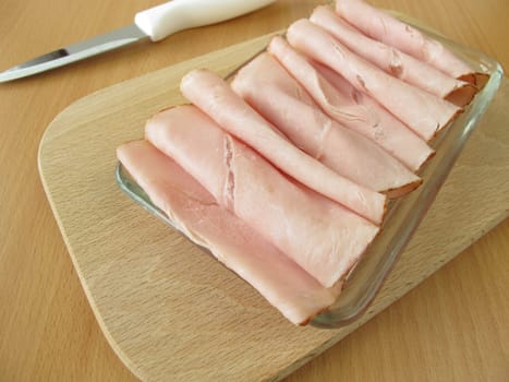 Cooked ham on a small glass plate